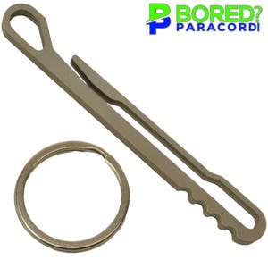 May include: A set of paracord tools, including a metal fid, a marlin spike, and a split ring. The tools are silver-colored and designed for crafting and working with paracord. The text "Bored? Paracord!" is in the upper right corner.