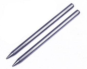 May include: Two silver knitting needles, approximately 10 inches long, with pointed tips.