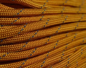 May include: Close-up of a coiled yellow rope with blue accents. The rope is made of a braided material and has a textured surface.