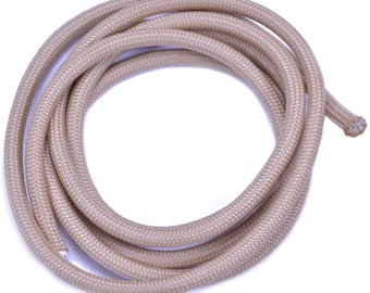 May include: A coil of tan paracord, a type of strong nylon rope often used for crafting and outdoor activities.