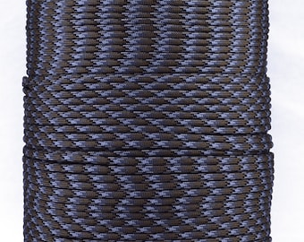 May include: A spool of black and brown camouflage paracord. The paracord is wound tightly around a cardboard spool.