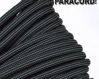 May include: A close-up of black and green paracord with a checkered pattern. The paracord is coiled and ready to be used for crafting or survival.