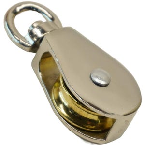 May include: A silver and gold single pulley with a swiveling eye hook. The pulley has a brass wheel and a silver metal frame.