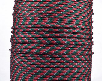 May include: A spool of red and green paracord with a white stripe running through it.