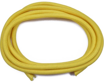 May include: A coil of bright yellow paracord, a type of strong nylon rope often used for crafting and outdoor activities.
