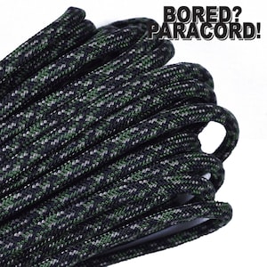 May include: Close-up of a black, green, and gray paracord rope. The rope is coiled and has a camouflage pattern. The text "BORED? PARACORD!" is visible in the upper right corner of the image.