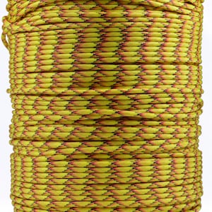 May include: A spool of yellow paracord with a black and red diamond pattern.