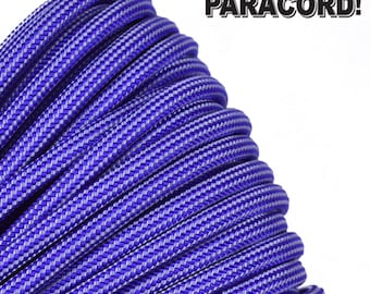 May include: Coiled blue and white paracord rope. The rope has a woven pattern and is tightly wound. Text in the upper right corner reads "BORED? PARACORD!"