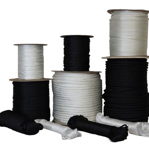 May include: Spools of white and black rope in various sizes. The rope is wound around cardboard spools.