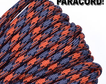 May include: Close-up of a spool of black and orange paracord. The paracord is woven in a checkered pattern. The text "BORED? PARACORD!" is visible in the upper right corner of the image.