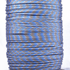 May include: A spool of blue and tan paracord with a diamond pattern.