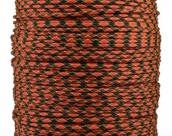 May include: A spool of red, black, and yellow paracord with a diamond pattern.