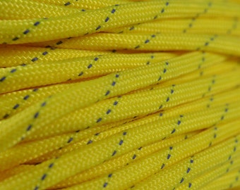 May include: Close-up of yellow paracord with blue accents. The paracord is tightly wound and shows the texture of the material.