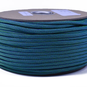 May include: A spool of blue and green paracord, a type of strong nylon rope, is wound tightly. The paracord is often used for crafting, camping, and survival.