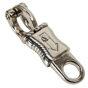 May include: A silver-colored swivel bolt snap with a spring-loaded gate and a ring at the end. The snap features a decorative design with an arrow. This hardware is suitable for various applications.
