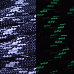 May include: Black and white paracord with a green glow-in-the-dark pattern. The paracord is woven together in a tight braid.