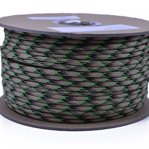 May include: A spool of green, black, and brown camouflage paracord.
