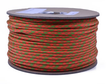 May include: A spool of red and green paracord, a type of strong nylon cord often used for crafting and outdoor activities.