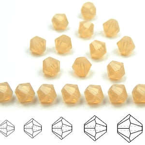 May include: A collection of 20 peach-colored faceted glass beads. The beads are arranged in a triangular pattern with a row of 10 beads at the bottom. The beads are approximately 4mm in diameter.