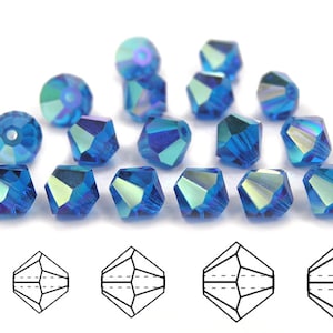 May include: A group of 18 blue crystal beads with a faceted design. The beads are arranged in a semi-circle on a white surface. A line of five black and white line drawings of the beads are shown below the beads.