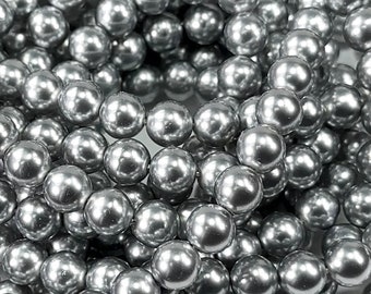 May include: A close-up of a strand of silver-colored pearl beads. The beads are round and smooth, and they have a high-gloss finish.