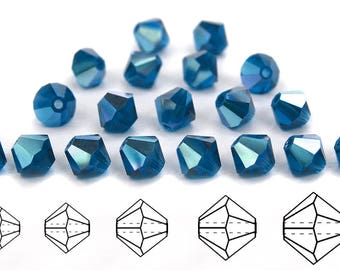 May include: A collection of 16 teal blue faceted glass beads. The beads are shaped like a pyramid with a square base. The beads are arranged in a random pattern on a white surface. A diagram of the bead shape is shown below the beads.