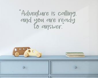 May include: A light blue dresser with two drawers. The dresser has a quote on the wall behind it that reads "Adventure is calling. And you are ready to answer."