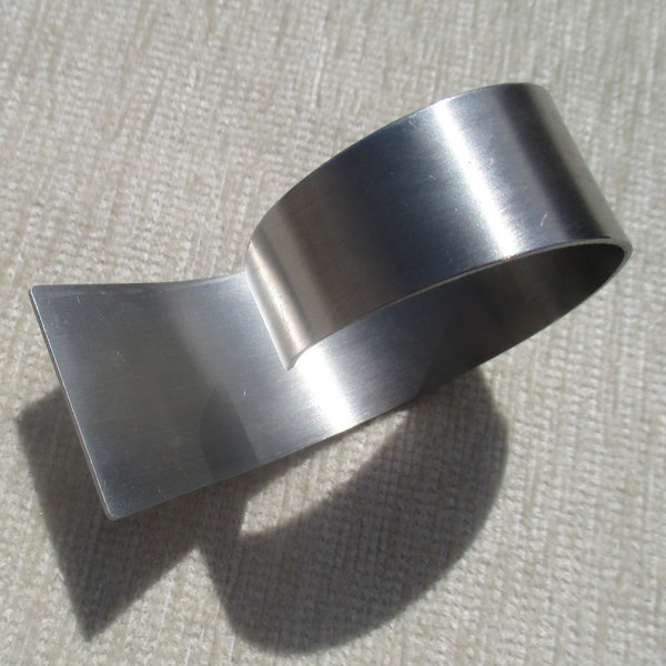 70s modernist napkin rings in brushed steel, open swirl MCM futurist table ware