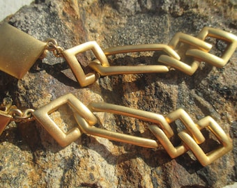 Signed dangle earrings by SPHINX in satin gold tone metal
