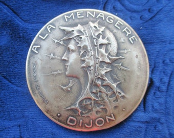 Genuine art nouveau pocket mirror, round shopping souvenir 'A la menagere', Swiss import, Joan of Arc style profile, worn silvered brass