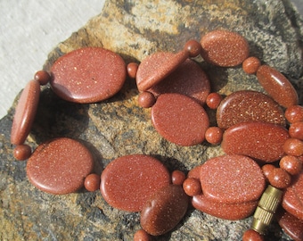 60s goldstone bead necklace, flat ovals with striations