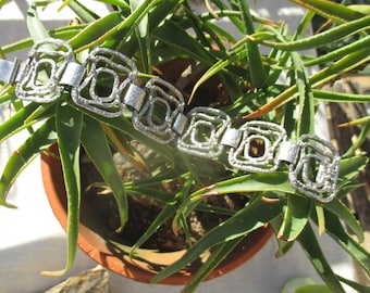 70s brutalist bracelet, shiny silver tone panels with abstract hand worked wire