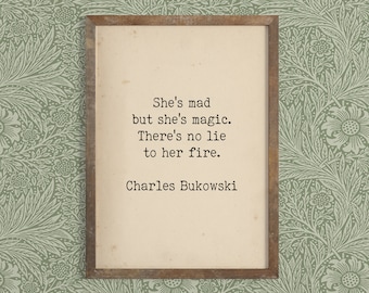 May include: A framed print with a quote by Charles Bukowski: "She's mad but she's magic. There's no lie to her fire."