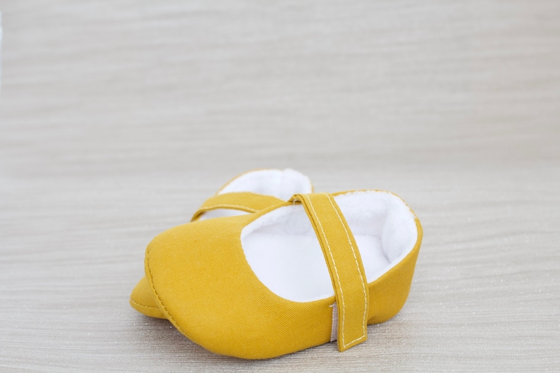 Mustard corduroy mary jane baby girls shoes with bow on strap.