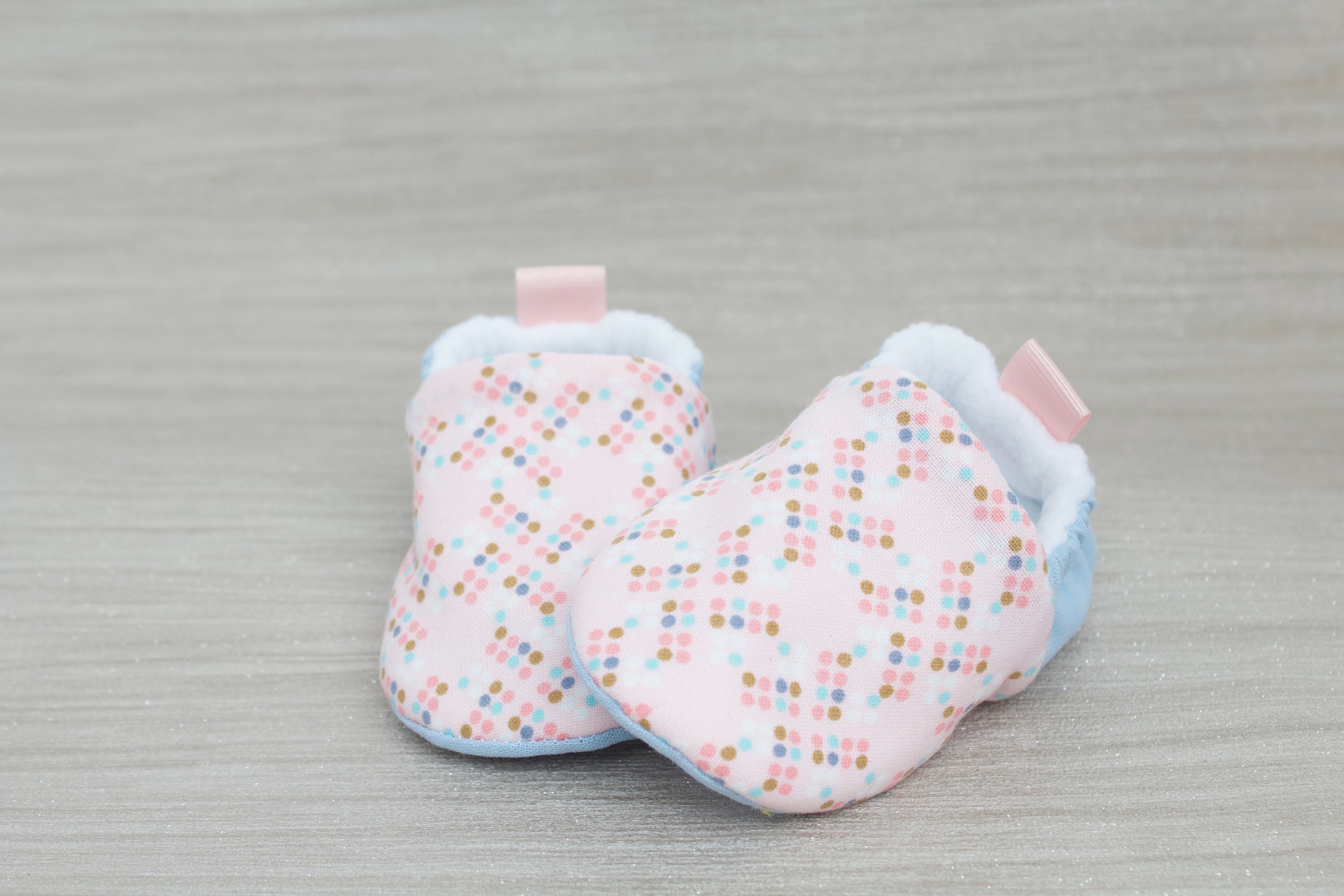 pink and blue baby shoes