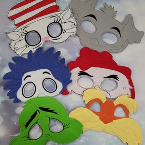 May include: Set of six felt character masks featuring characters from the book "The Cat in the Hat". The masks are in various colors, including red, blue, green, yellow, white, and gray. Each mask has a unique facial expression and features, such as a cat's whiskers, a Grinch's frown, and Thing 1's red hair.