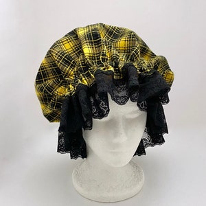 May include: A yellow and black plaid shower cap with black lace trim.