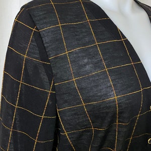 May include: Black sheer top with a gold grid pattern.