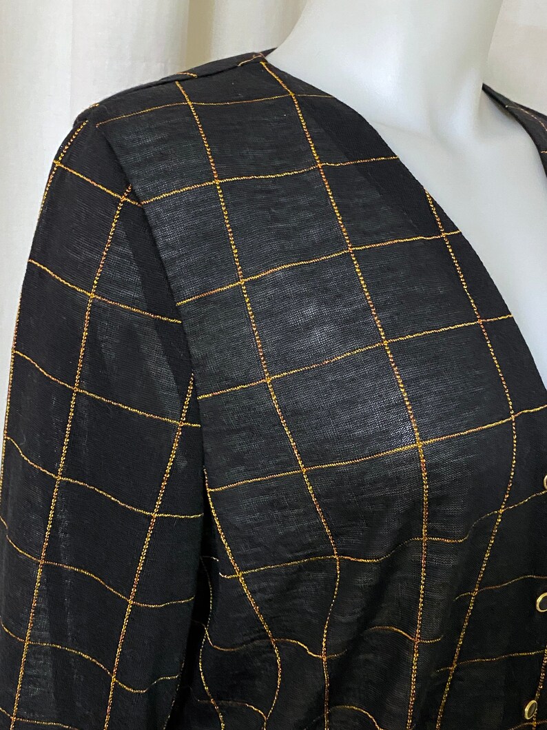 May include: Black sheer top with a gold grid pattern.