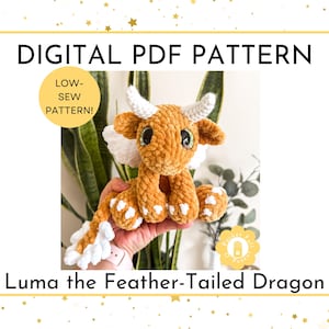 May include: Digital PDF pattern for a crocheted dragon named Luma. The plush dragon is orange with white accents on its wings, feet, and tail. It has large, expressive eyes and white horns. The text reads "Low-Sew Pattern!"