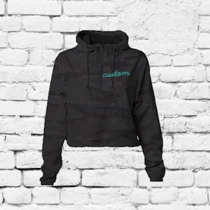May include: Black camo print hooded jacket with a zipper closure and a "Your Custom Print" text on the front.