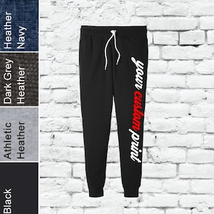 May include: Black sweatpants with a white and red "your custom print" design on the right leg.