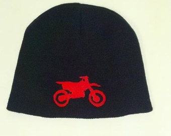 May include: Black knit beanie with a red embroidered motocross bike design.