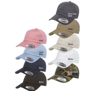 May include: A collection of 10 baseball caps in various colors, including pink, light blue, navy, black, khaki, stone, white, green camo, and dark gray. The caps are all the same style, with a curved brim and a small logo on the front.