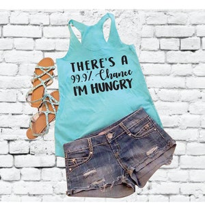Puede incluir: Un top de tirantes turquesa con el texto "There's a 99.9% Chance I'm Hungry" en letras negras.