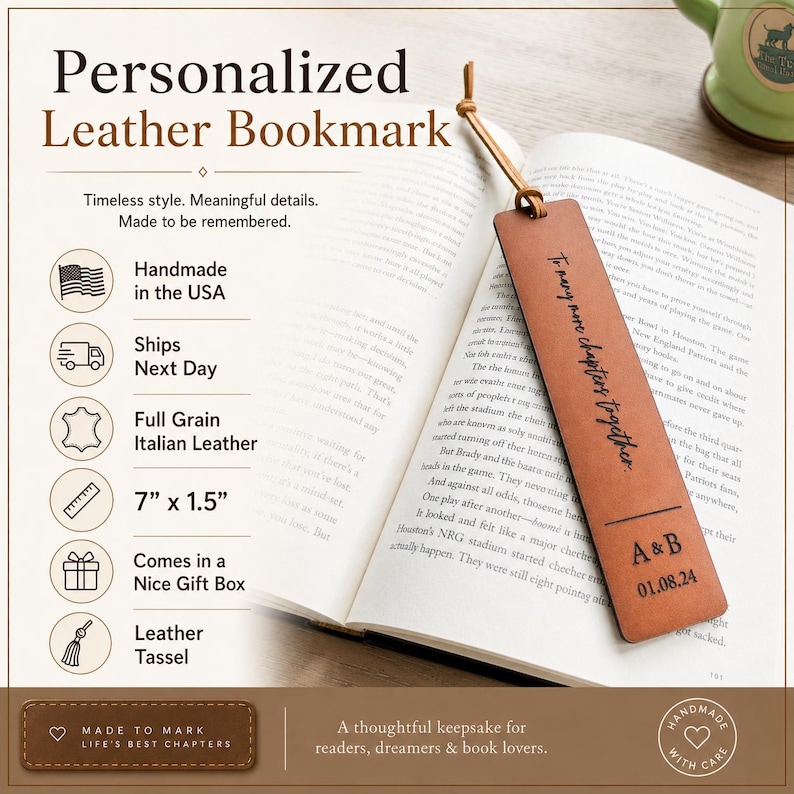 May include: A rectangular brown leather bookmark with a leather tassel, featuring the engraved text 'To many more chapters together' and 'A & B' with the date '01.08.24'. The bookmark measures 7 inches by 1.5 inches and rests on an open book.