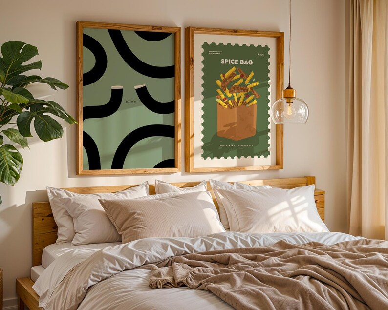 Illustration poster depicting two Guinness Glasses forming the famous "Split the G" shape against a sage green backdrop with the word "Slainte!" This Guinness Print Slainte wall art is perfect home décor for a Home Bar, kitchen, or dining room. It makes a wonderful Christmas gift, a cute Christmas gift for a friend, and a perfect Valentine gift for him or her. The iconic Irish design is ideal for Guinness enthusiasts, Irish men, or anyone seeking a playful accent in their living space.