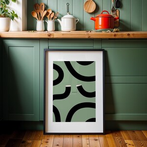 Guinness Print Slainte illustration poster featuring two iconic Guinness Glasses forming the "Split the G" shape on a sage green background with bold black curves and creamy foam tops. This Irish art wall print is perfect home décor for a Home Bar, man cave, or Dublin-inspired kitchen. It makes a thoughtful Christmas gift, a cute Christmas gift for a friend, and a perfect Valentine gift for him. Ideal for Guinness drinkers, Irish men, or anyone who loves iconic Irish artwork.