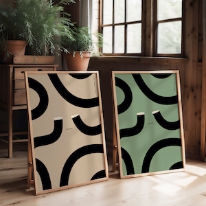 Two popular Guinness prints side by side one in biege and one in green. Abstract wiggly guinness pint glasses with cheers in the middle. Large kitchen bar style print art work. Original Guinness designs a gift for a guinness drinker at christmas