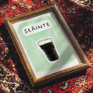 Unique guinness christmas present art print a guinness glass and slainte hand drawn with a pastel green background to represent the irish colours